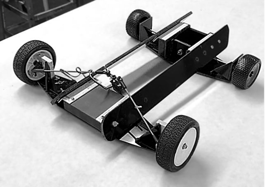 The first remote-controlled testbed lacked a rubberband motor, but was useful for testing basic steering geometry and a rear differential.
